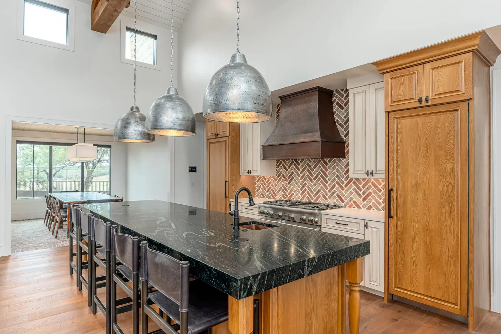 Hill Country timeless modern kitchen with natural wood cabinetry and herringbone backsplash