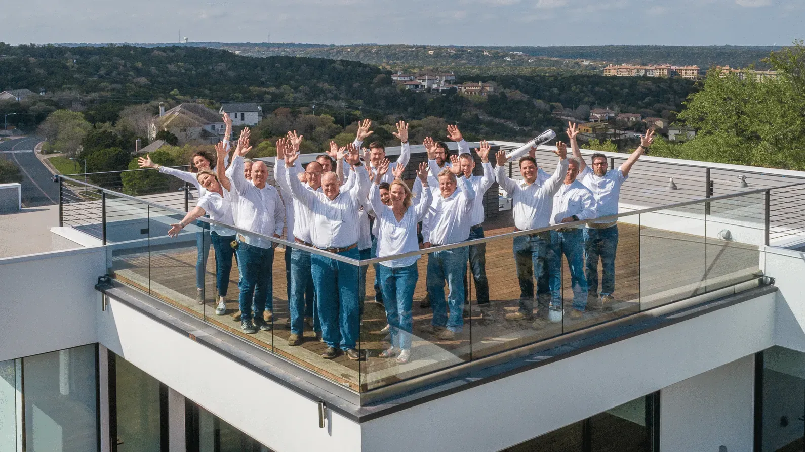Jenkins Design Build team standing atop their office building in Bee Cave, TX