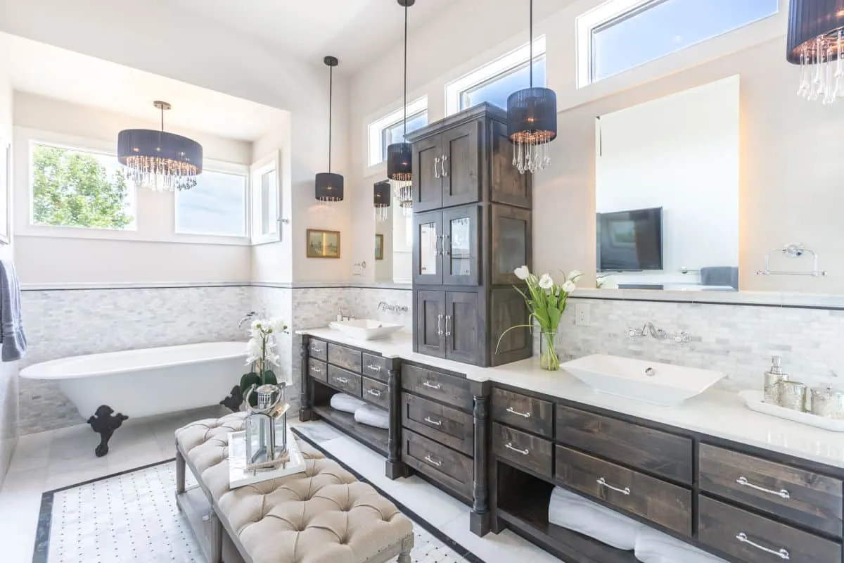 master bath, bathroom, bath tub, standing bath tub, luxury, luxury bath, jenkins, custom homes, jenkins custom homes, chandeliers, bathroom chandeliers, bathroom furniture, bathroom cabinets, bathroom sinks, sinks, mirrors, bathroom windows, windows, bathroom tiles, tiles, white tiles, wooden cabinets, bench