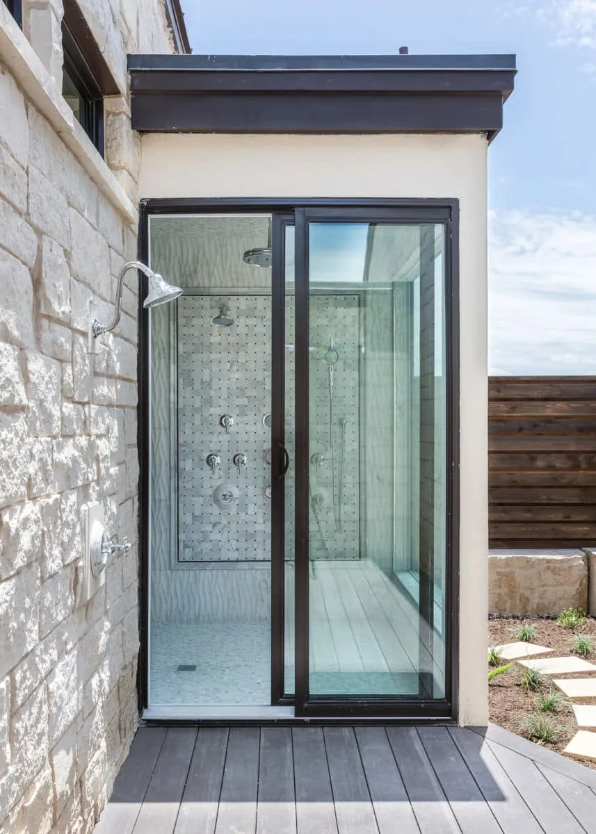 shower, outdoor shower, farmhouse, rustic, white stone, wooden floor, beach, glass windows, glass door, beach shower, white washed wood, jenkins, luxury, hill country