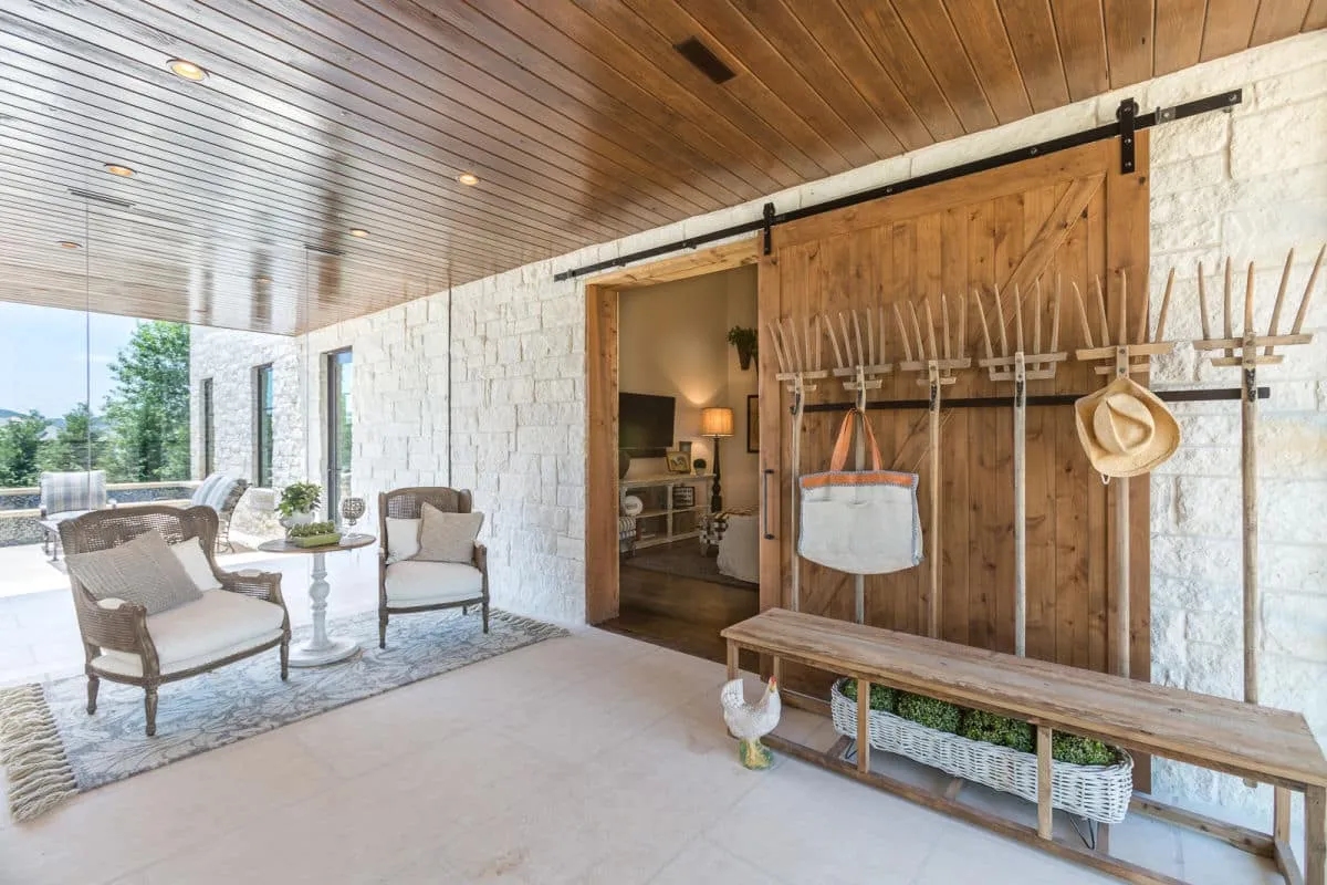modern, farmhouse, wooden bench, lighting, large windows, wooden, lights, chairs, luxury, home, homes, custom homes, jenkins, hill country, stone, white stone, sliding door, glass windows, entryway, entrance, farm, rustic, wooden ceiling, stone floors, stone walls, cowboy, southern
