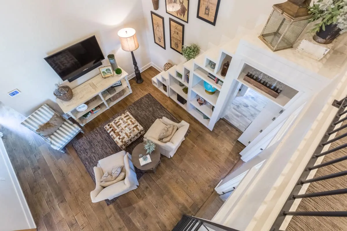 jenkins, hill country, loft, living room, farmhouse, modern, luxury, custom home, custom homes, home, bookcase, staircase, library, wooden floor, furniture, couches, chairs, rustic, white walls, metal ladder, ladder to loft