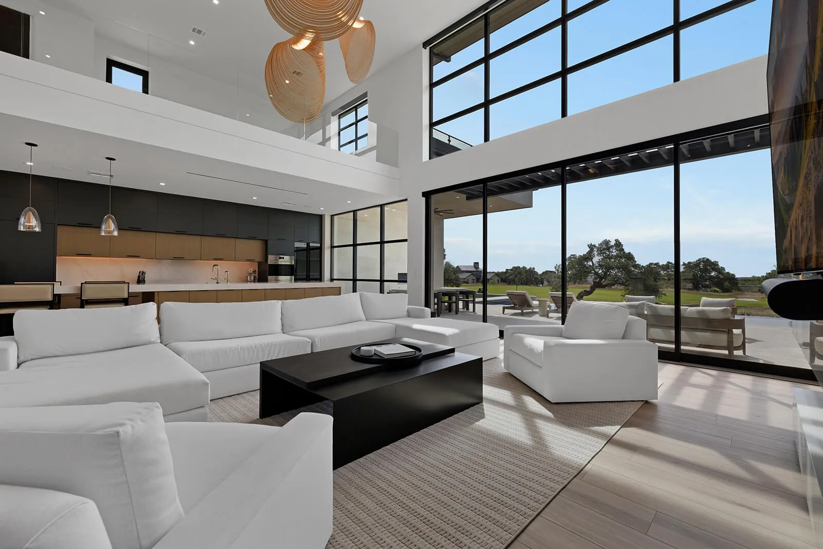Two-story glass wall in contemporary Austin living room