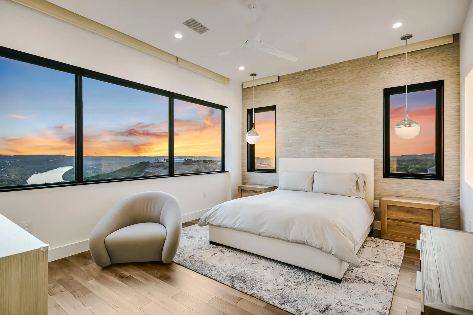 Austin luxury bedroom with soft neutral palette and sunset view