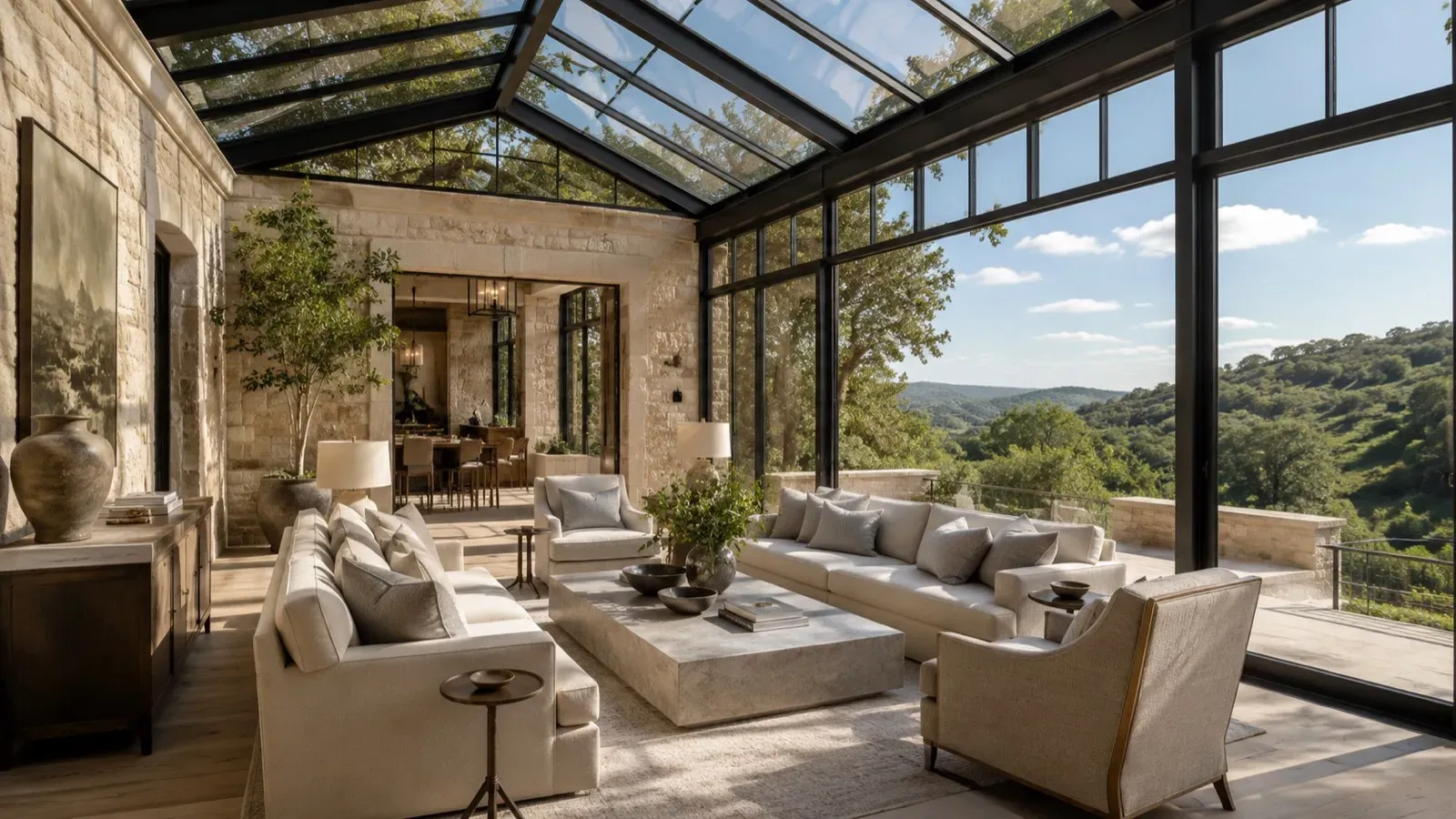 Interior of a glass-roofed conservatory with white oak flooring and limestone detailing in a Central Texas home.