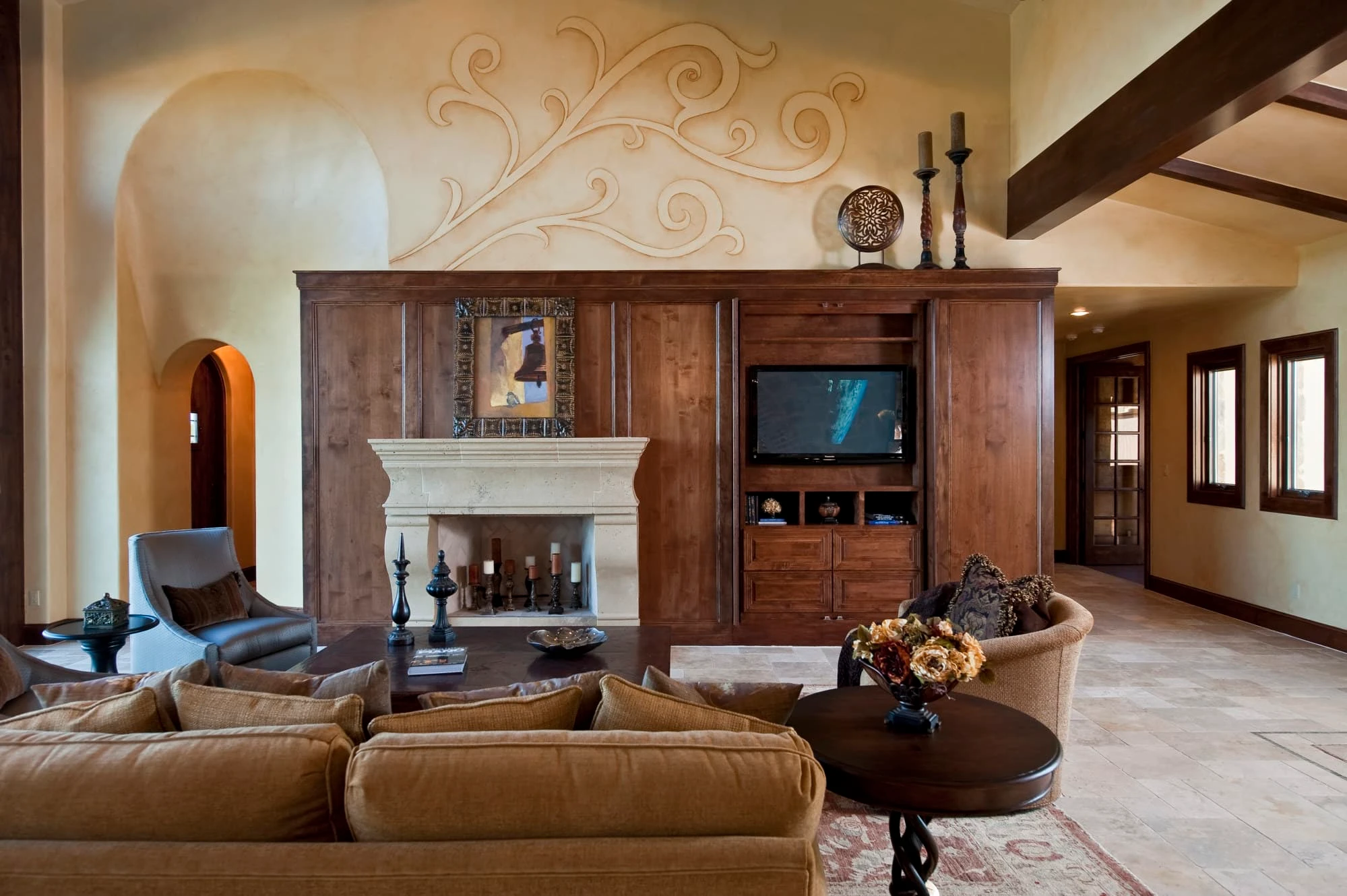 Fireplace wall straight on with plaster scroll, arched niche and TV cabinet, Modern Mediterranean Parade Home