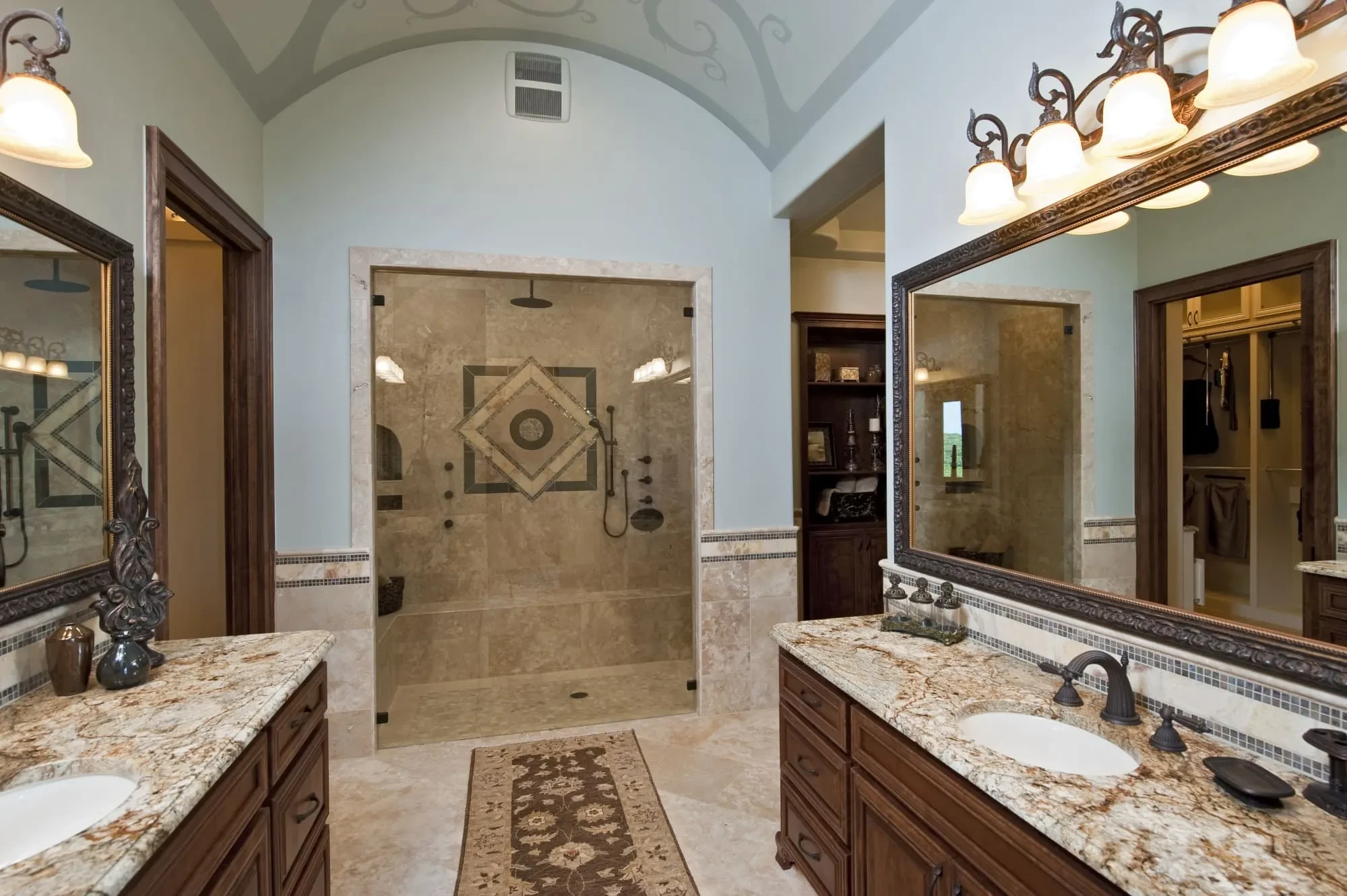 Bathroom with walk-in tiled shower, double granite vanities and barrel-vaulted ceiling, Modern Mediterranean Parade Home