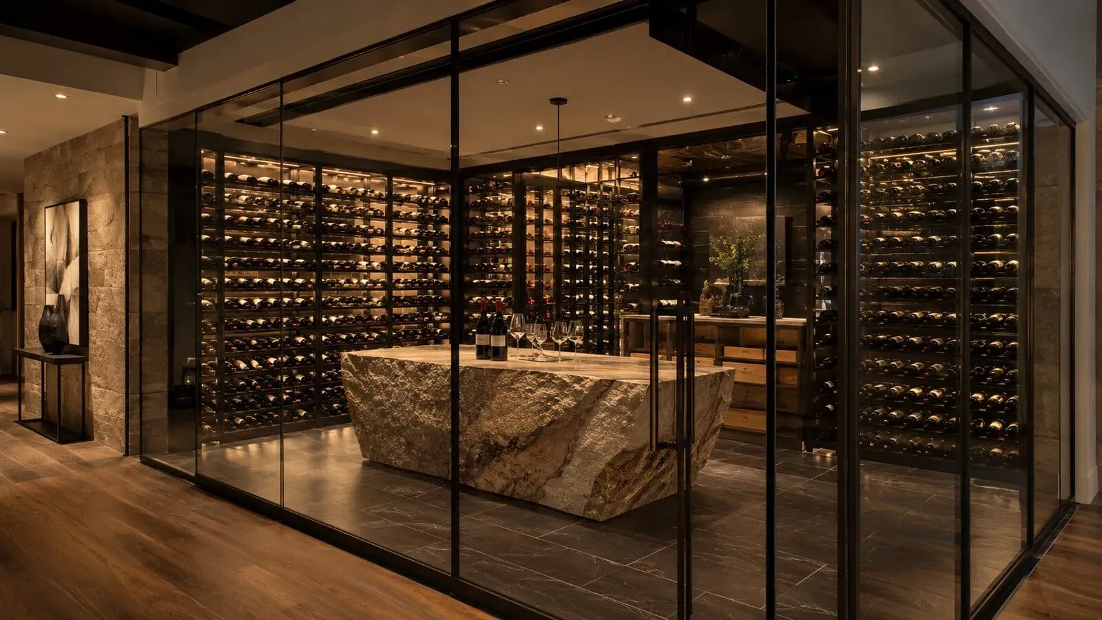 Custom glass-enclosed wine room with backlit racks and a stone tasting counter in a luxury Austin home