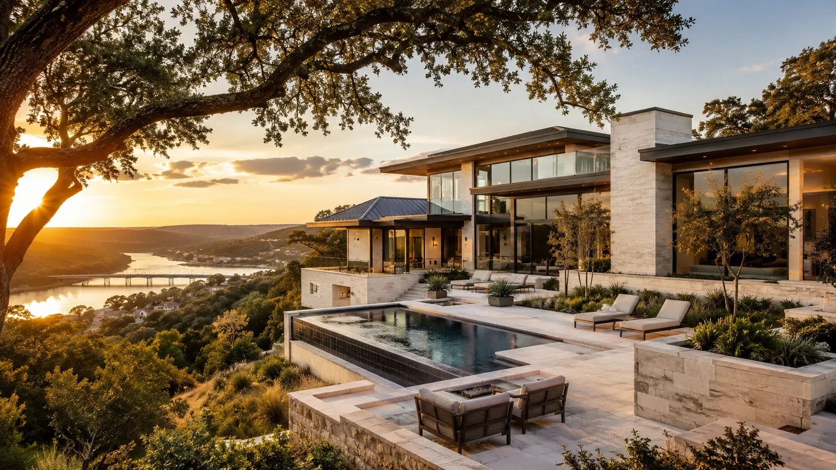 Luxury custom home with a limestone and glass exterior on a Hill Country hillside at golden hour in Davenport Ranch, Westlake, Austin