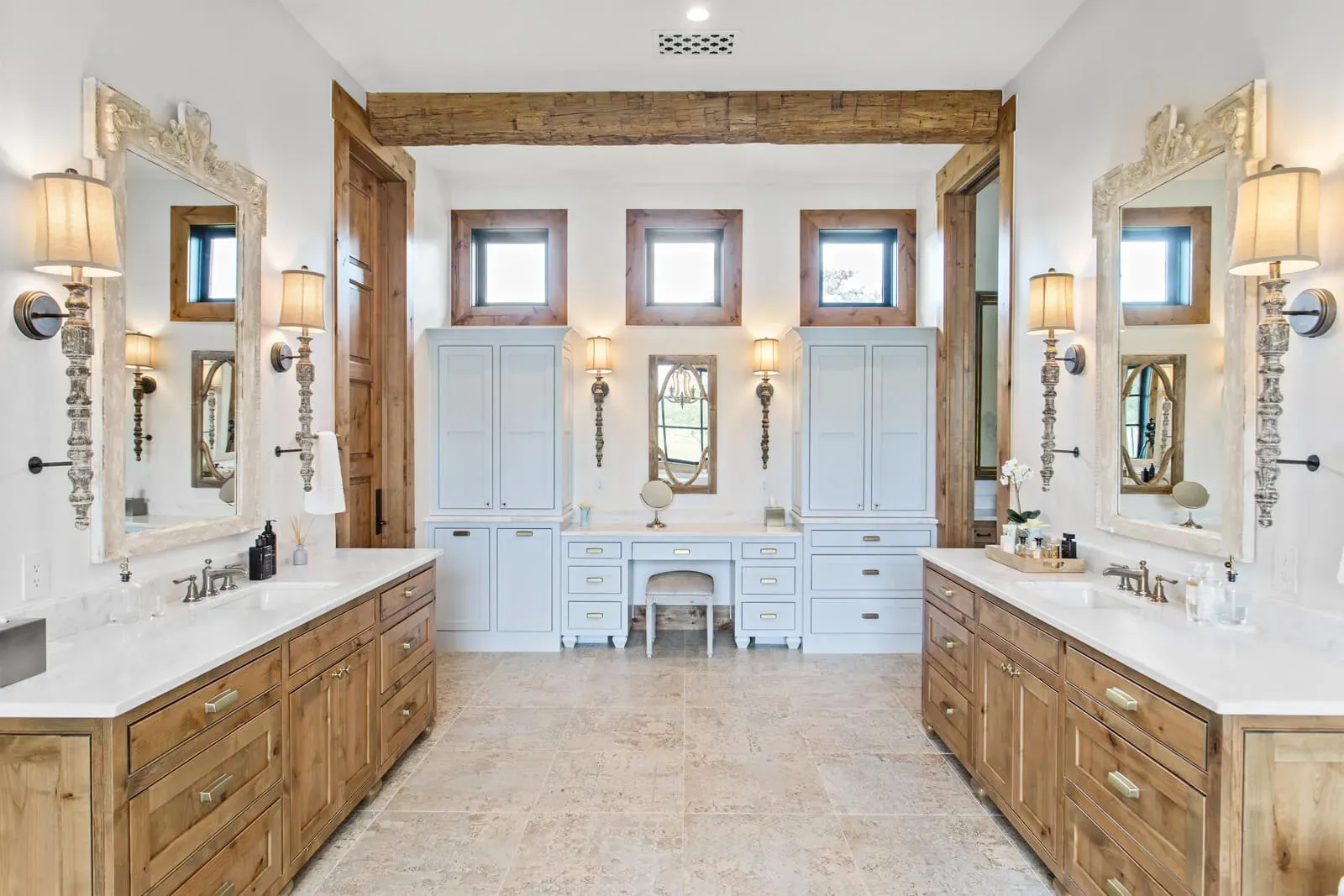 luxury bathroom with marble floor and wood cabinetry