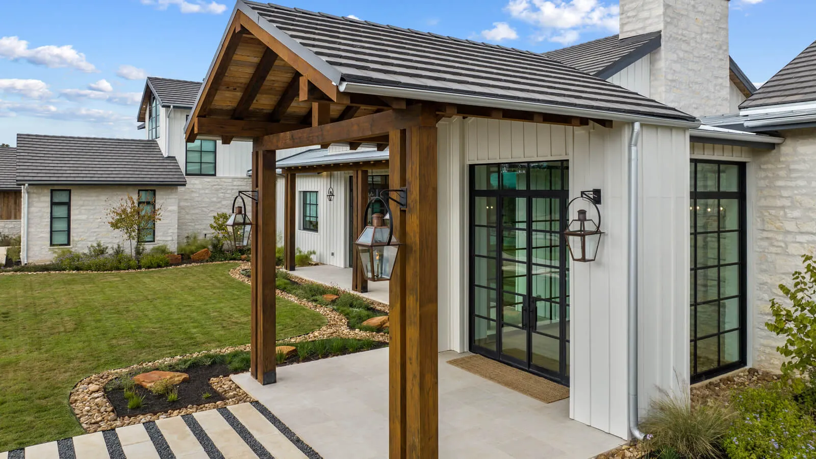 Hill Country contemporary luxury home exterior in Austin with timber entry and limestone façade