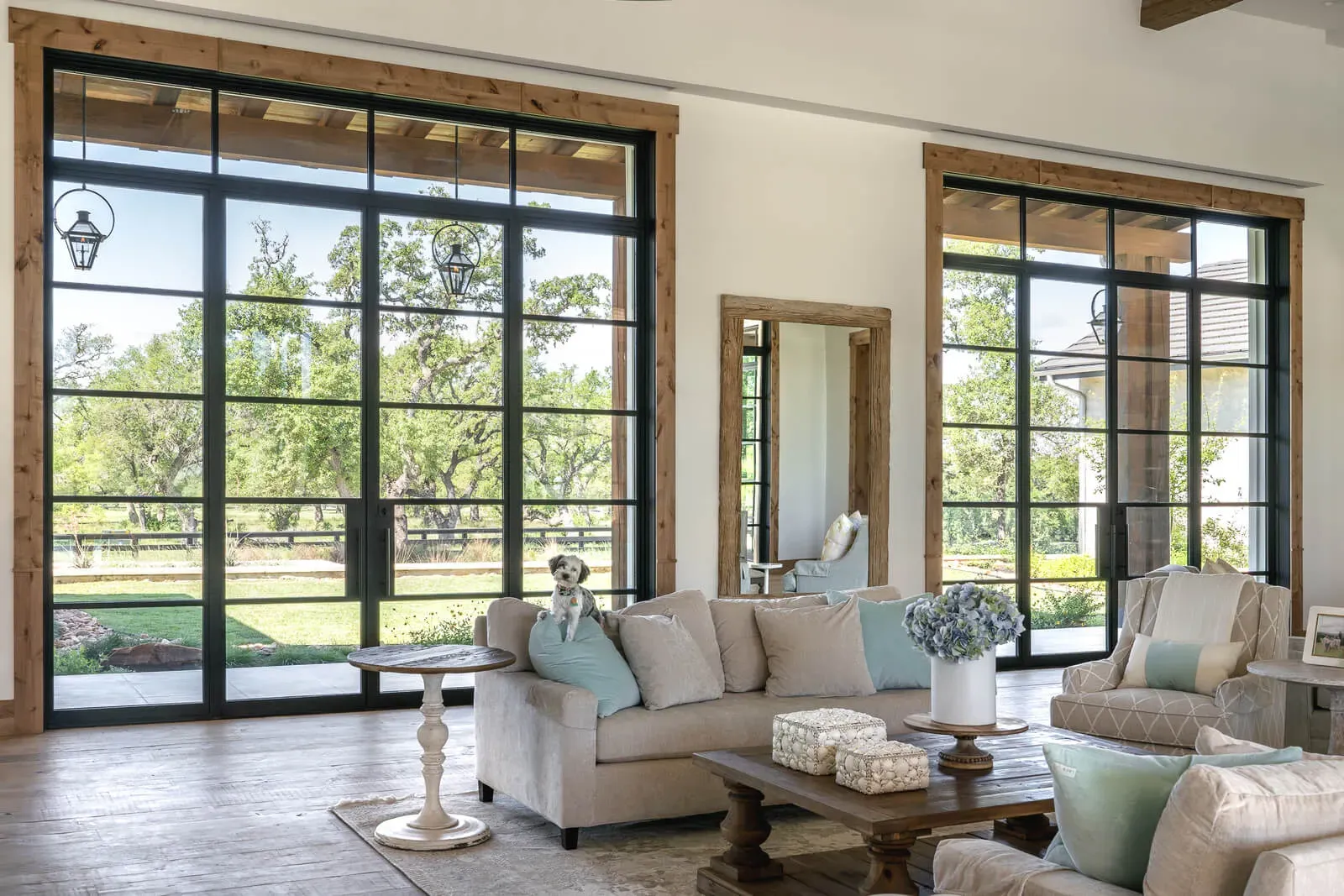 Open-plan living room in Hill Country contemporary home featuring steel-frame windows and panoramic views