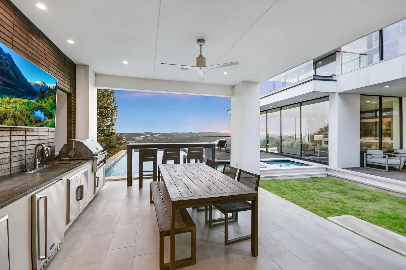 Indoor-outdoor timeless modern kitchen Austin Hill Country with stone walls and bar seating