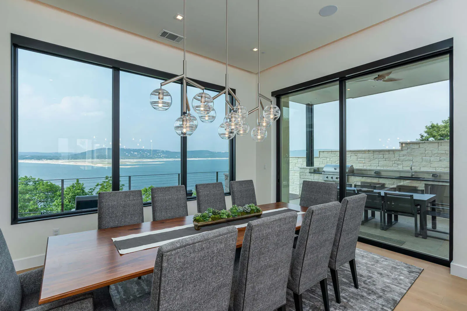 Dining room with lake view in green luxury home