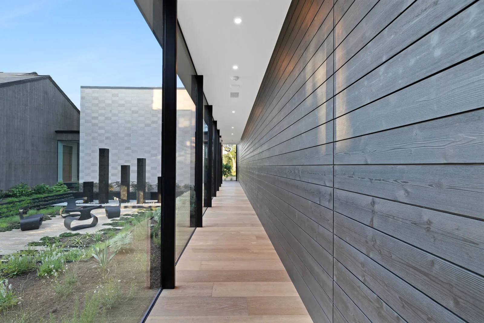 Glass corridor overlooking modern architectural courtyard