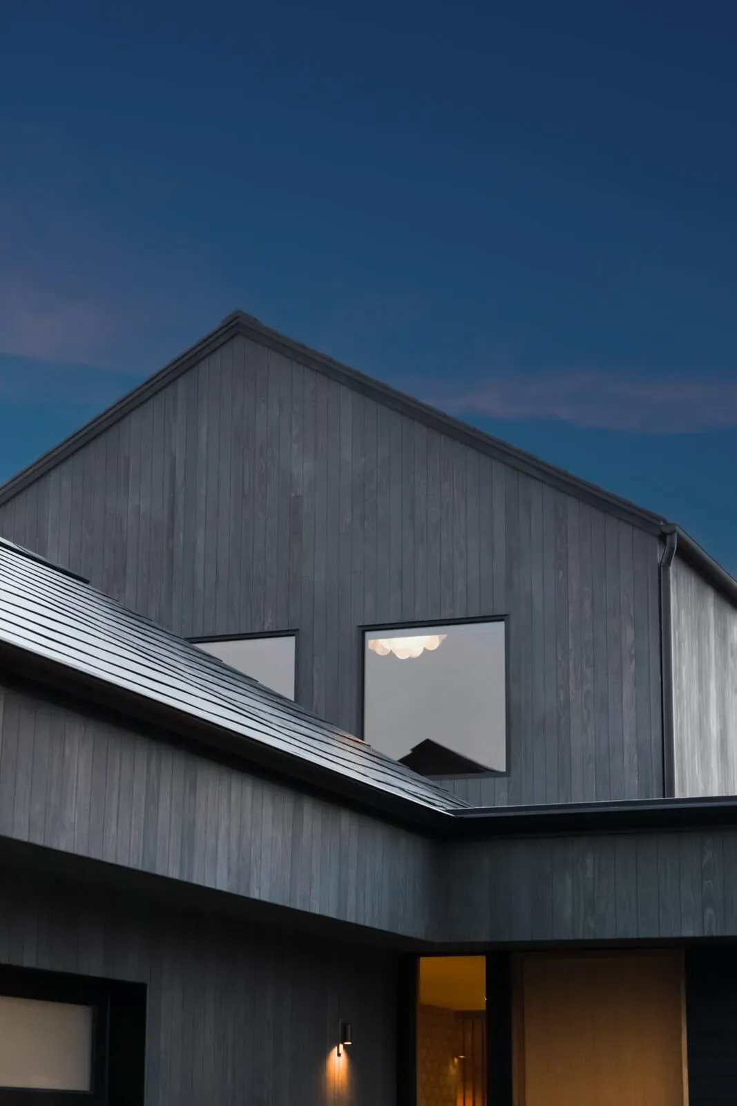 Modern net zero home exterior with black wood