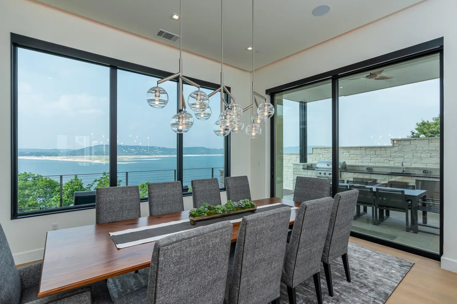 Modern dining room with Lake Austin views and floor-to-ceiling glass