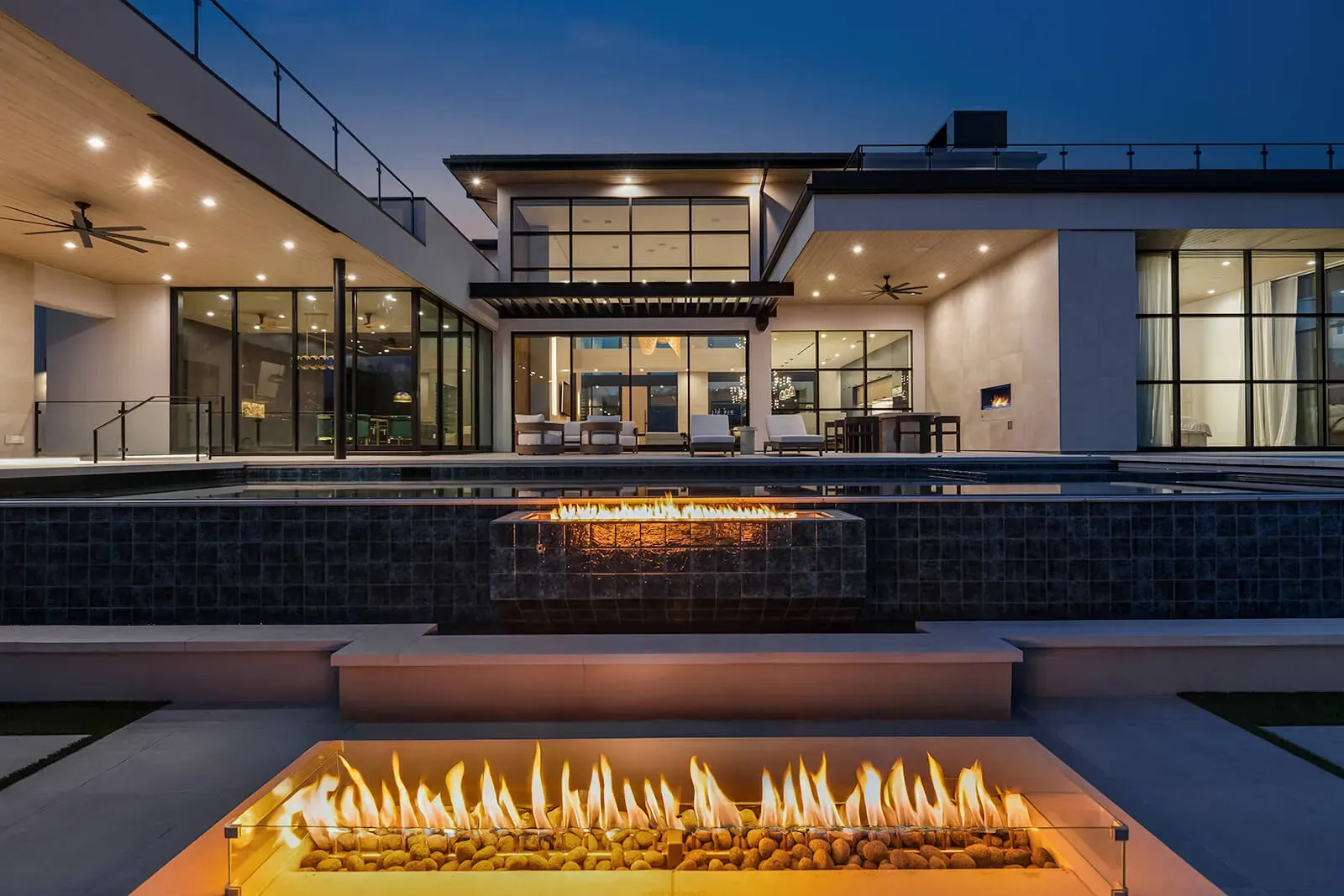 Modern Austin estate with multi-level pool, fire feature, and expansive glass walls