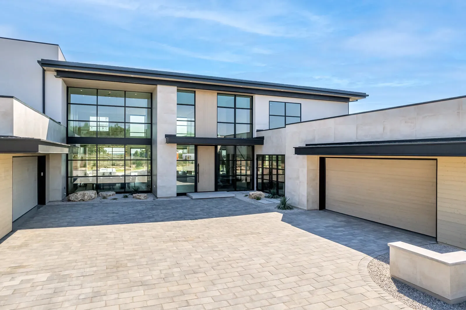 Modern two-story Austin home with flat roof and large glass walls in Driftwood