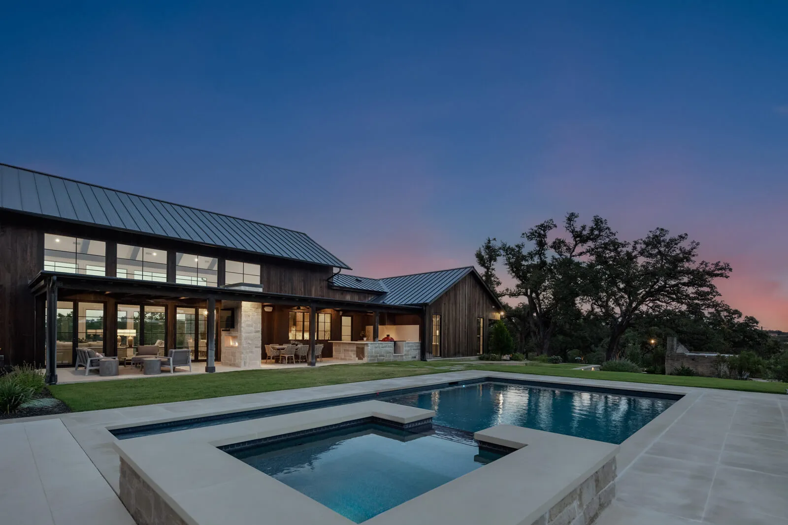 Net zero luxury home with pool at sunset