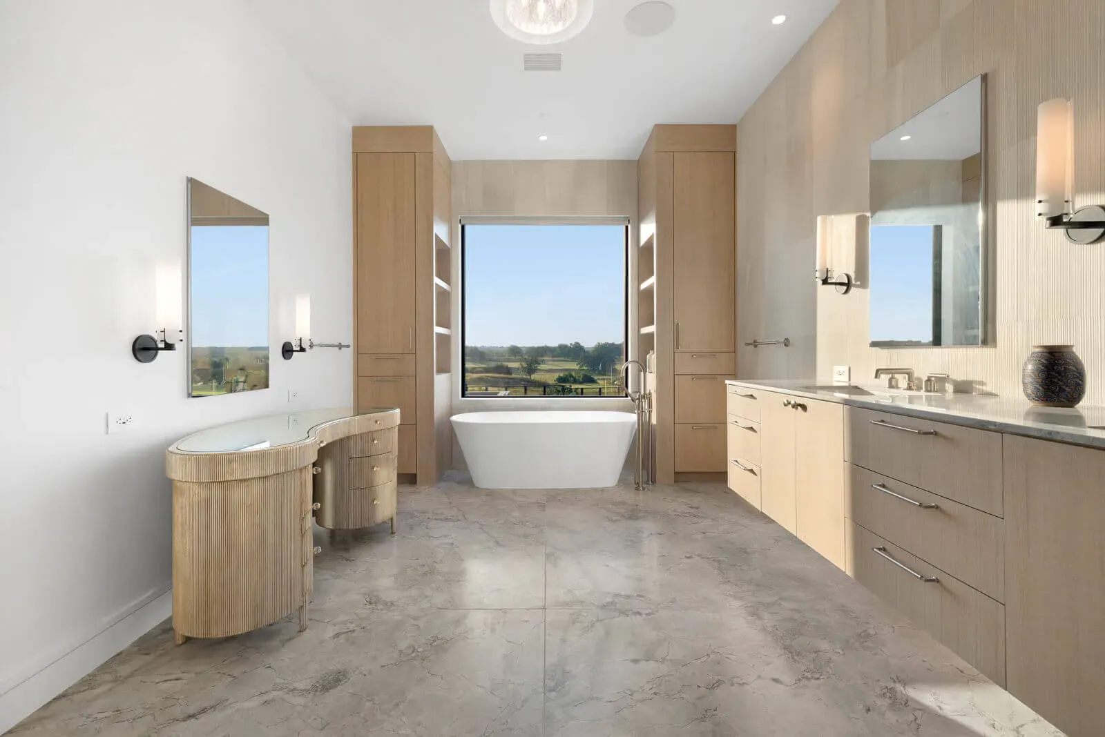 Austin luxury primary suite double vanity with stone tile and Hill Country outlook