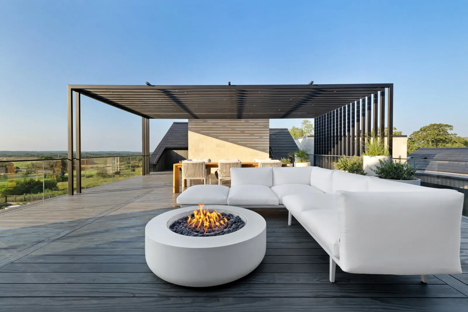 Rooftop lounge with modern fire table and panoramic Hill Country views
