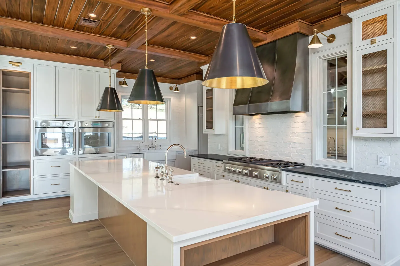 Custom range hood balancing oversized island in Austin estate kitchen