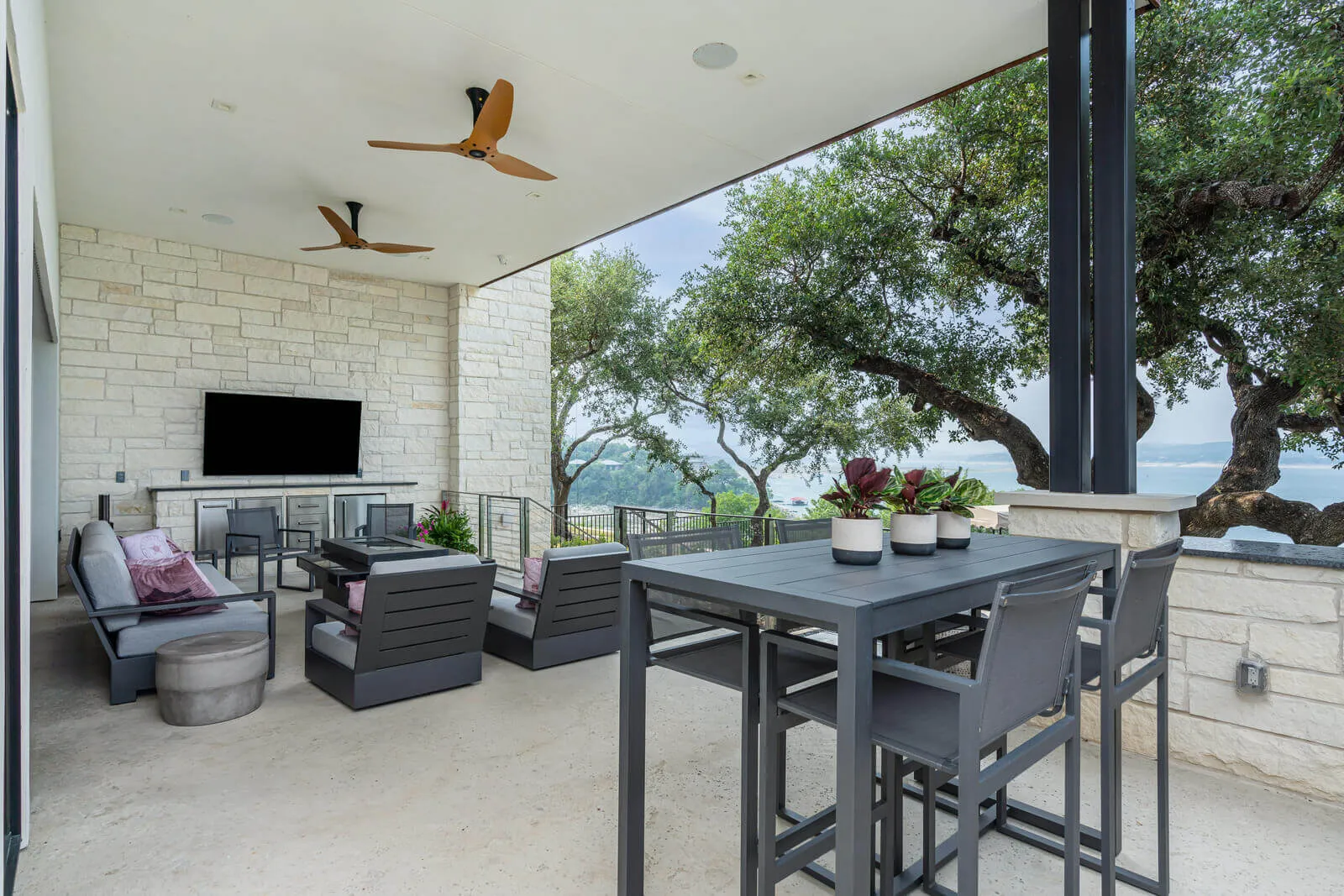 Modern Westlake terrace with mounted outdoor television and lake views